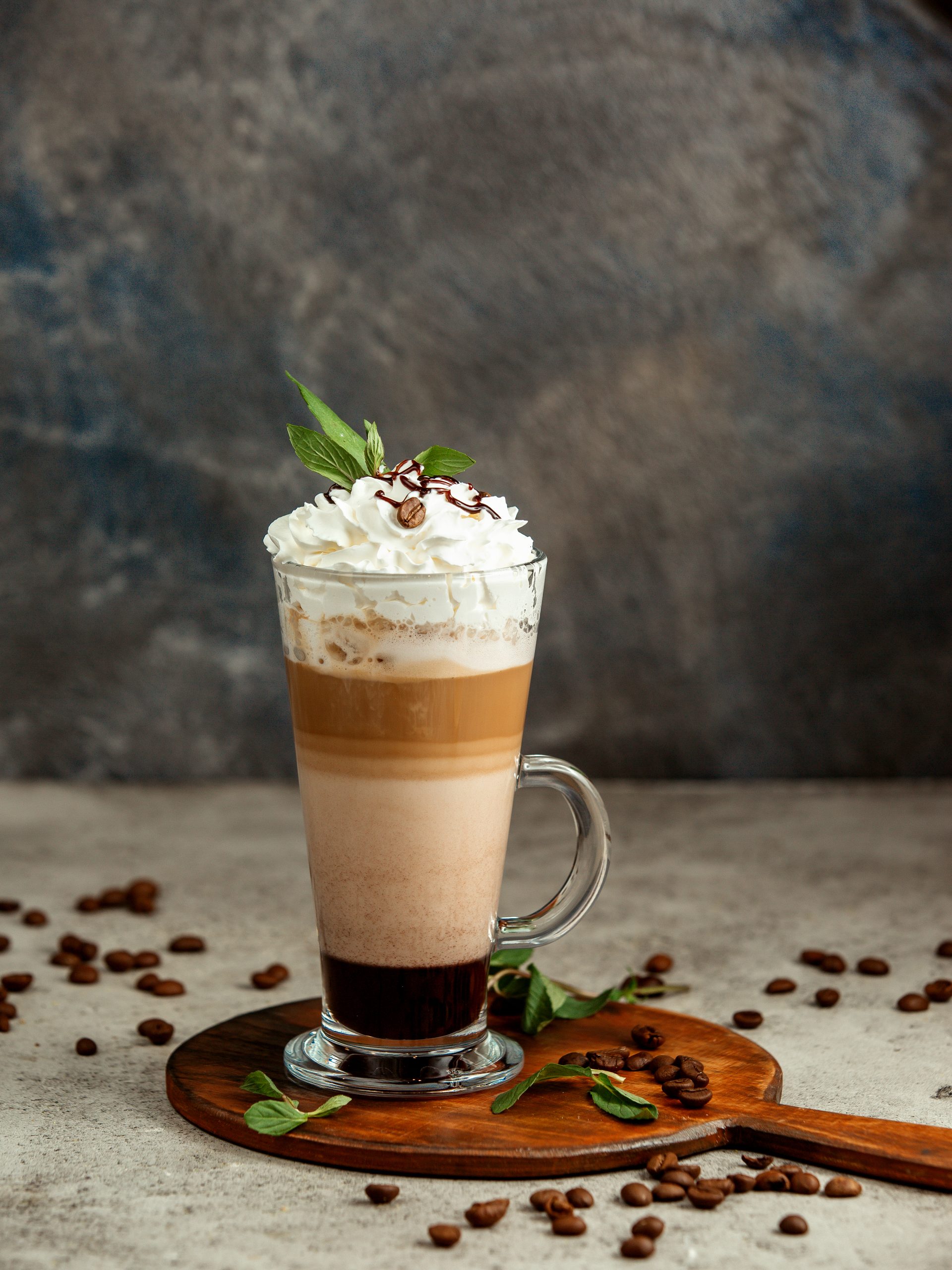 a cup of three layered coffee in dark background